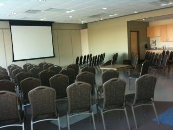 Langendorf Multipurpose Room B is prepared for a presentation using a projector, with plenty of seating for a mid-sized audience