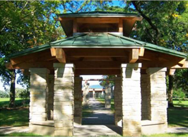 John Larkins Bell Gazebo is a small open-walled gazebo with a roof made of wood and metal and stone supports